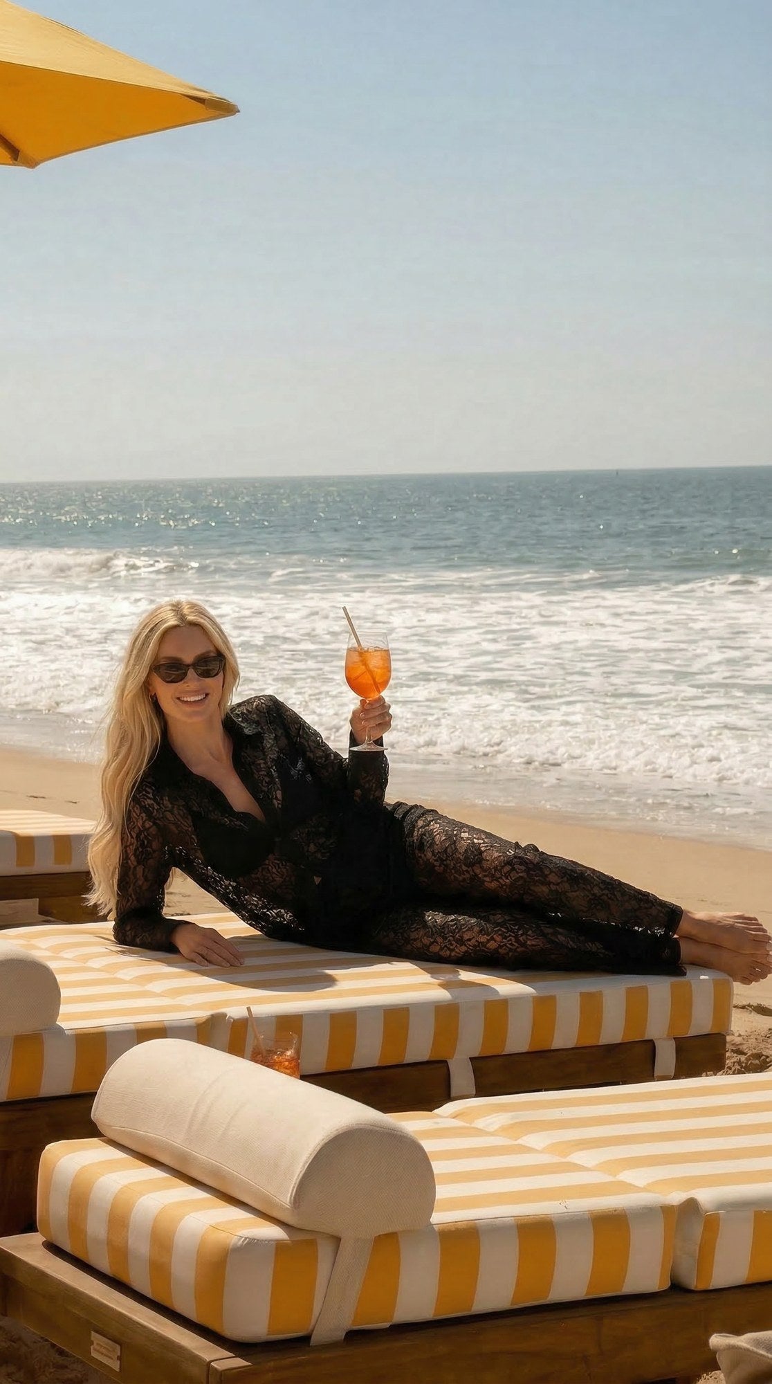 Model in the Lace Set shirt and trousers on a beach daybed